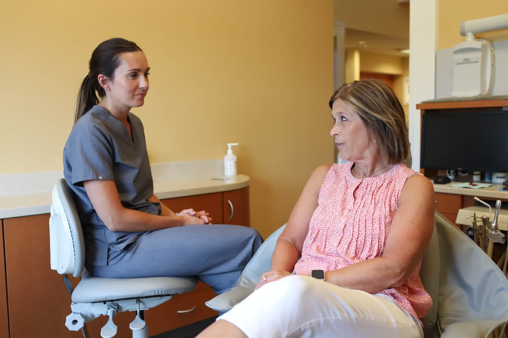 A Grandville Dental team member discussing care with a seated patient
