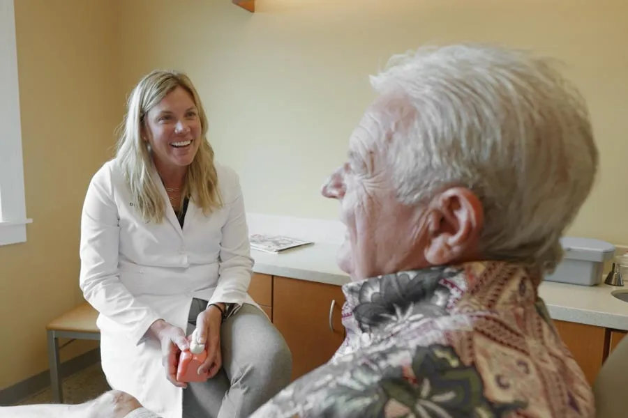 A Grandville Dental clinician listening to an older patient during a consultation
